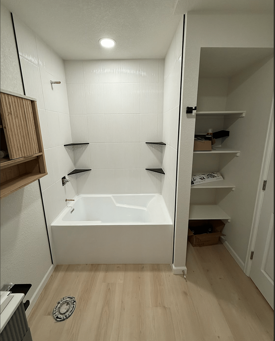 Bathroom now finished, but this shows large tub & storage shelving area