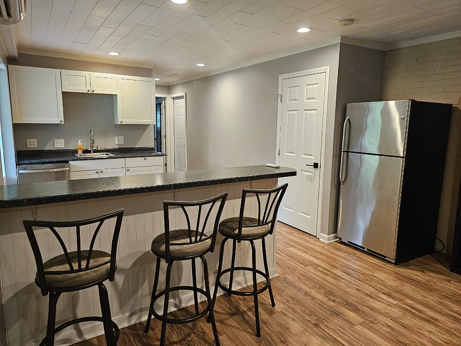Kitchen with bar stool dining, large storage closet
