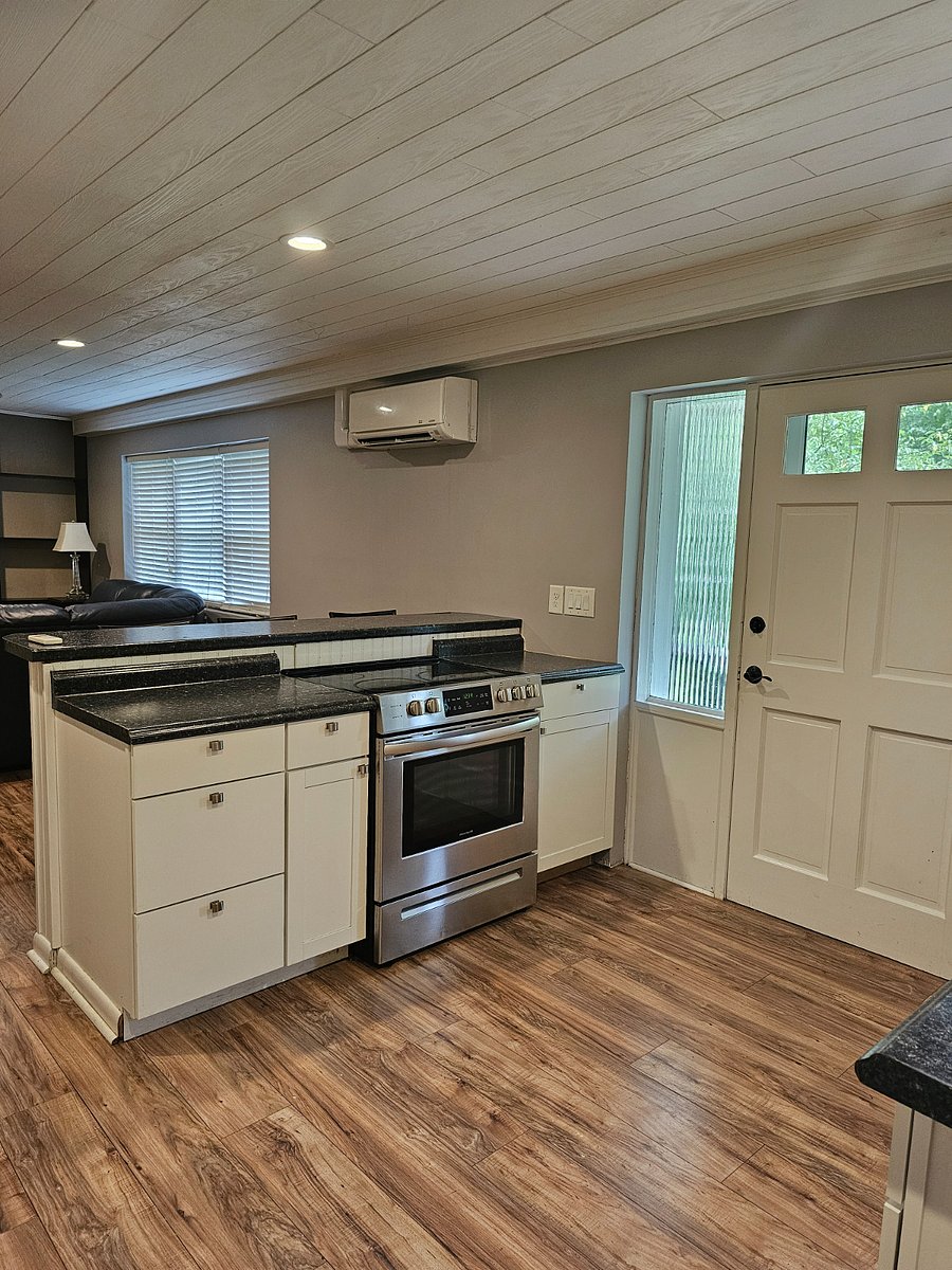 Kitchen with range and stove. Pots, pans and cookware provided.