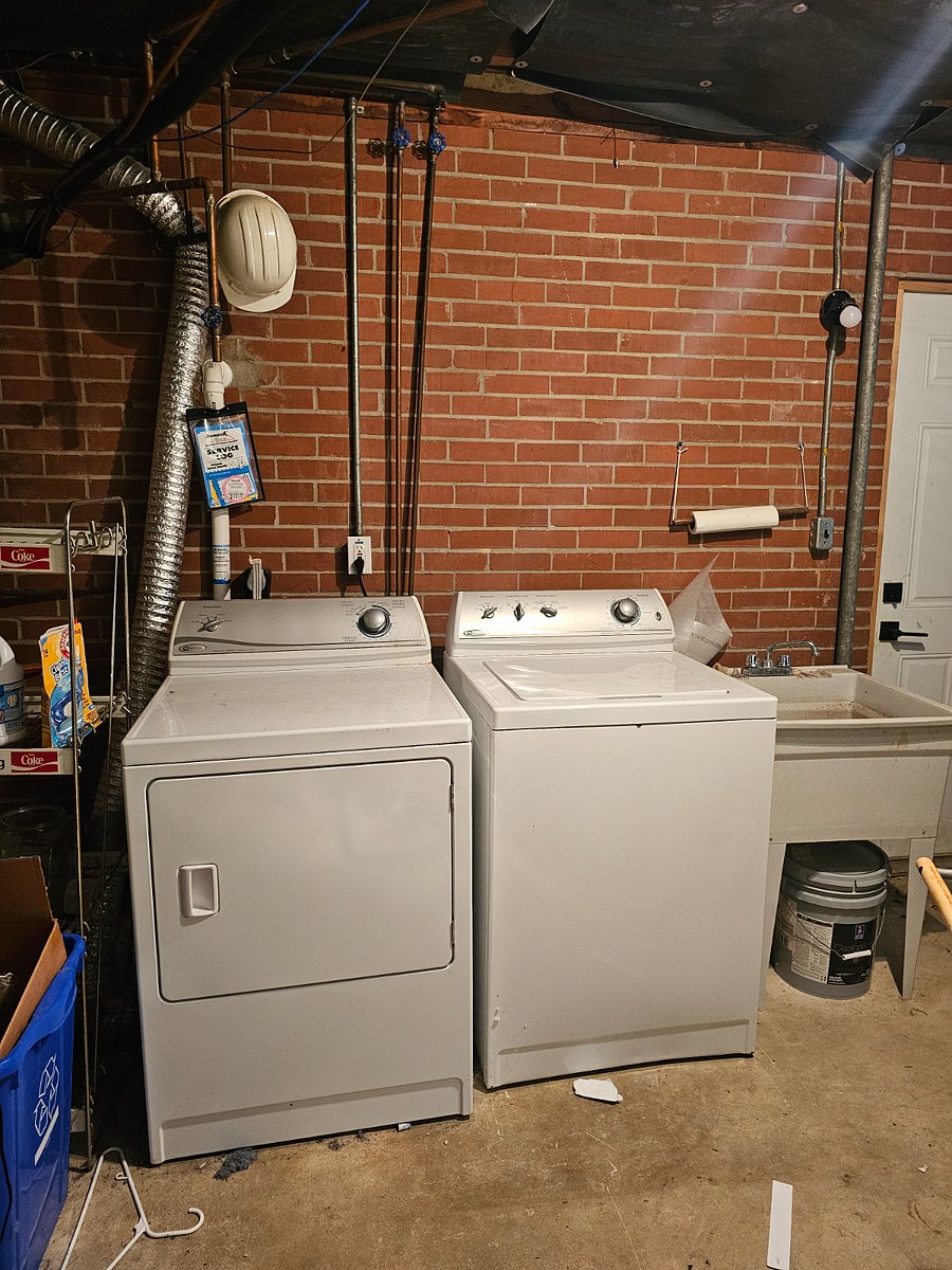 :Laundry room with washer, dryer, utility sink, storage and an additional separate entrance.
