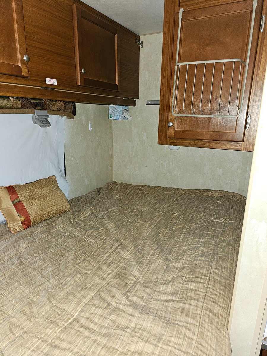 Full Size Bed. More Cabinets above