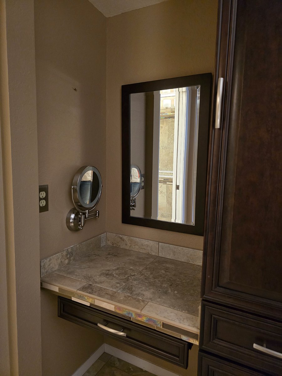 Make up space with magnifying mirror and linen cabinet.