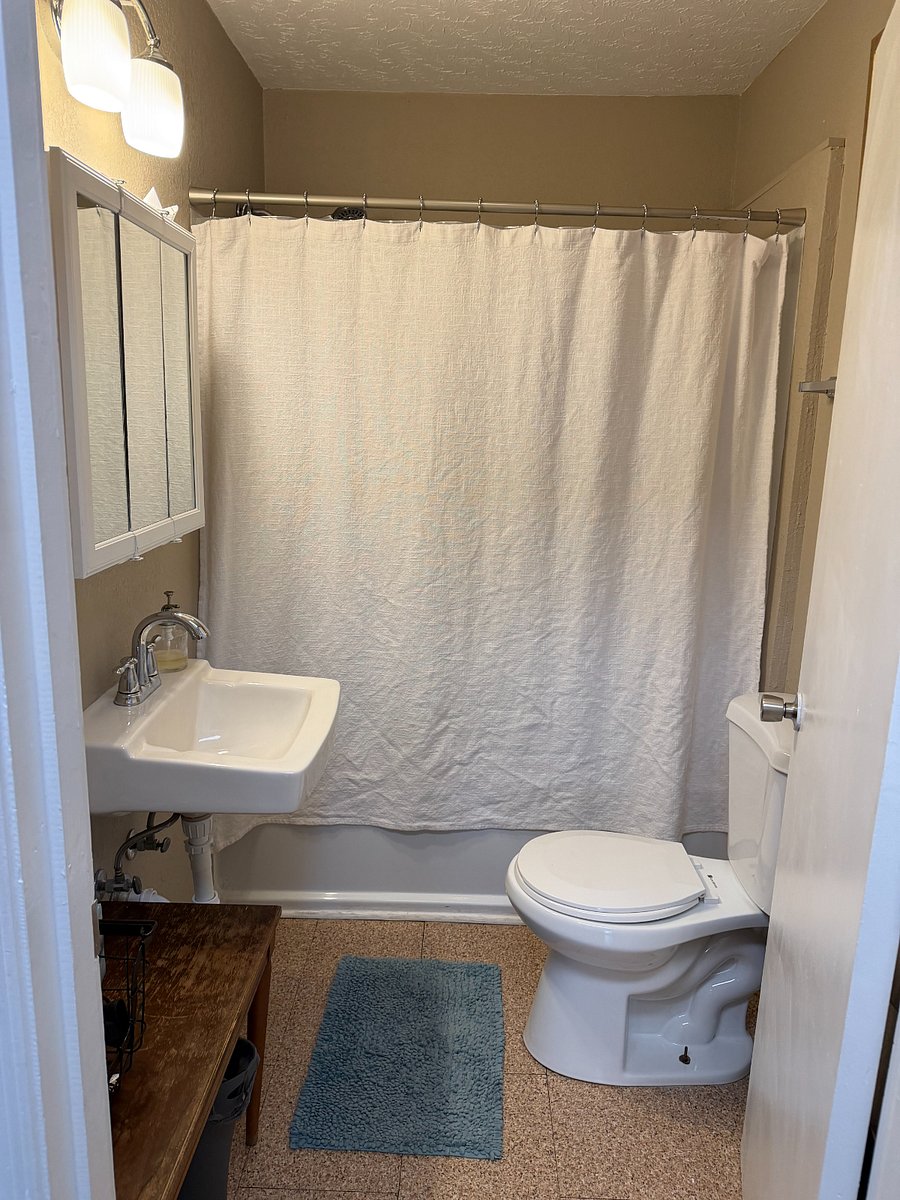 Bathroom with Vanity Mirror, Table for Bathroom Items (Linen closet in hall), Full Tub, & Removable Shower Head - Great water pressure!