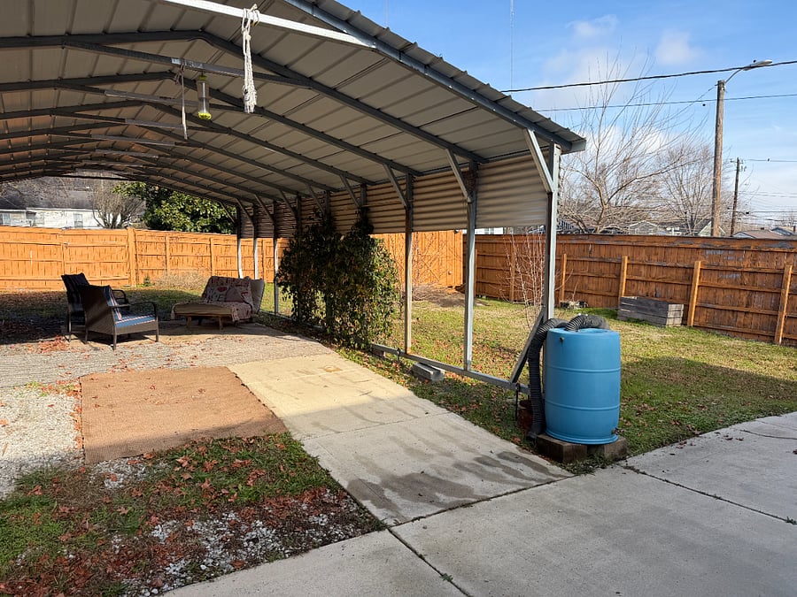 Fully Fenced Backyard has Large Gate to park under carport or use the carport as a very private hang space.
