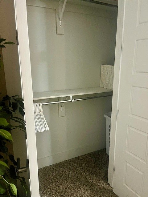 closet in bedroom - with hangers and laundry basket