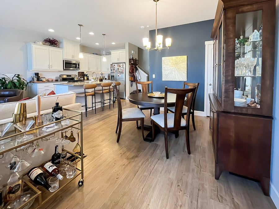 Shared downstairs living area including kitchen and dining table and couch.