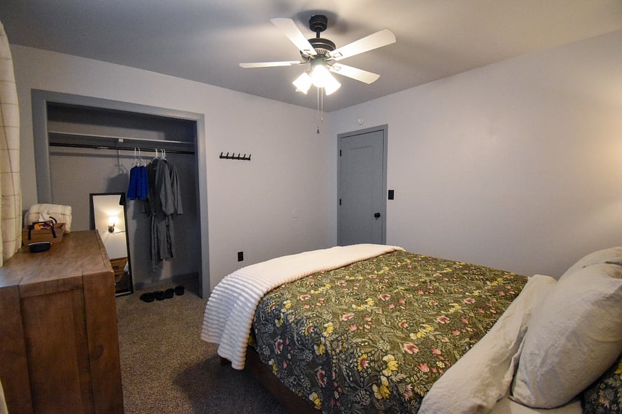 A tidy space with local artwork, mirror, and extras for comfortearplugs, a white noise machine, and plush robes, towels, and slippers for the hot tub.