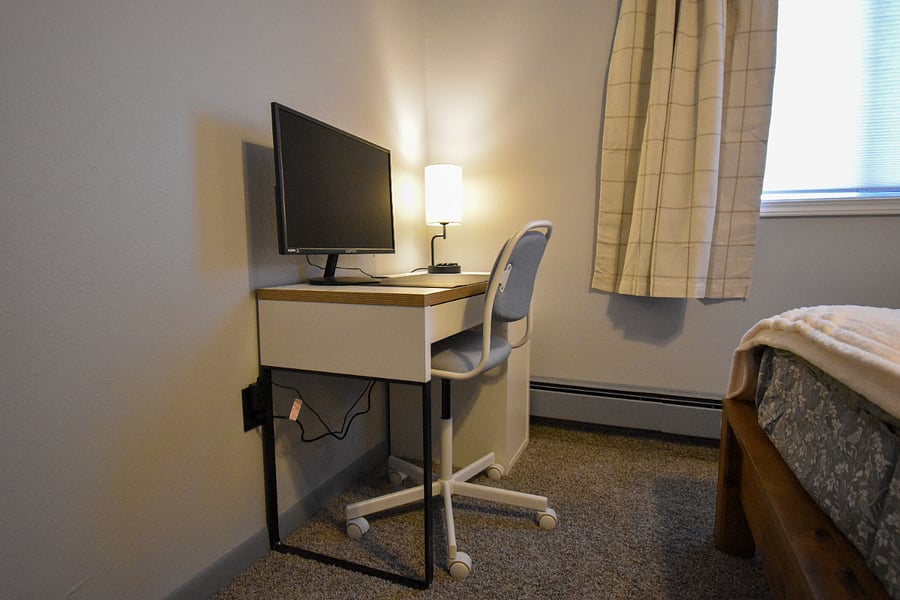 A quiet spot to get things done, featuring a desk, lamp, and monitor with HDMI cables provided for easy laptop connection. Perfect for remote work, studying, or checking in while youre away.