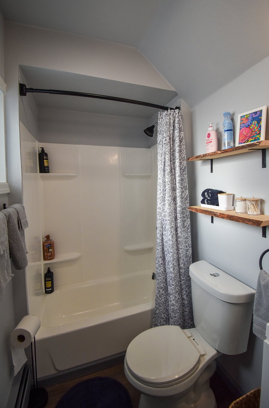 A newly refinished bath tub and shower, with a convenient clothesline that makes it easy to hang swimsuits after a soak in the hot tub.