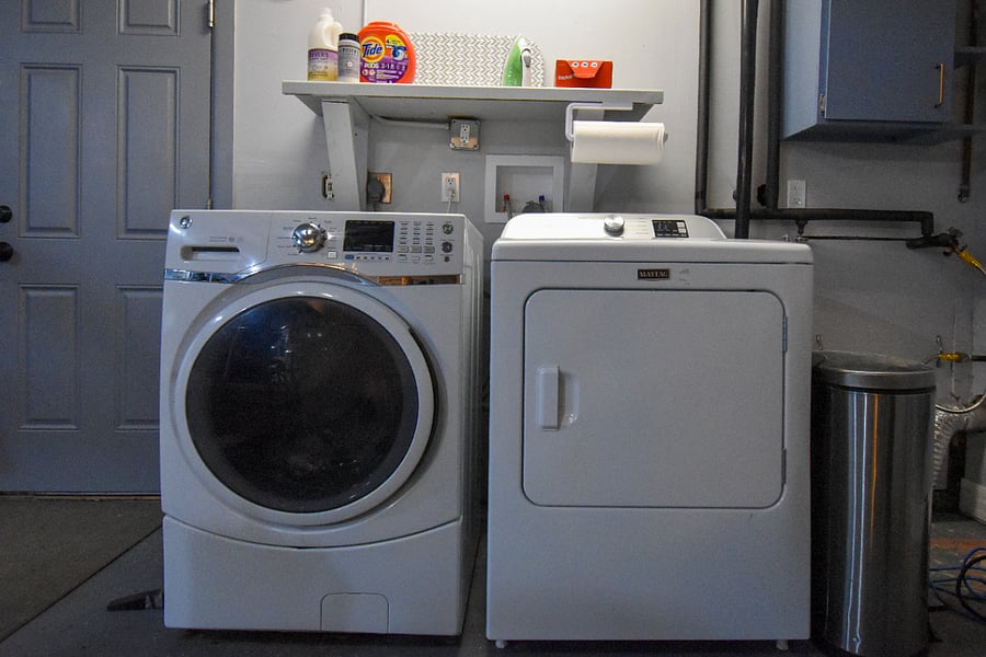 Convenient laundry area in the attached heated garage, just across from the lower unit. Washer, dryer, detergent, and dryer sheets are provided, along with an iron, ironing board, and drying rack for hang-dry items.