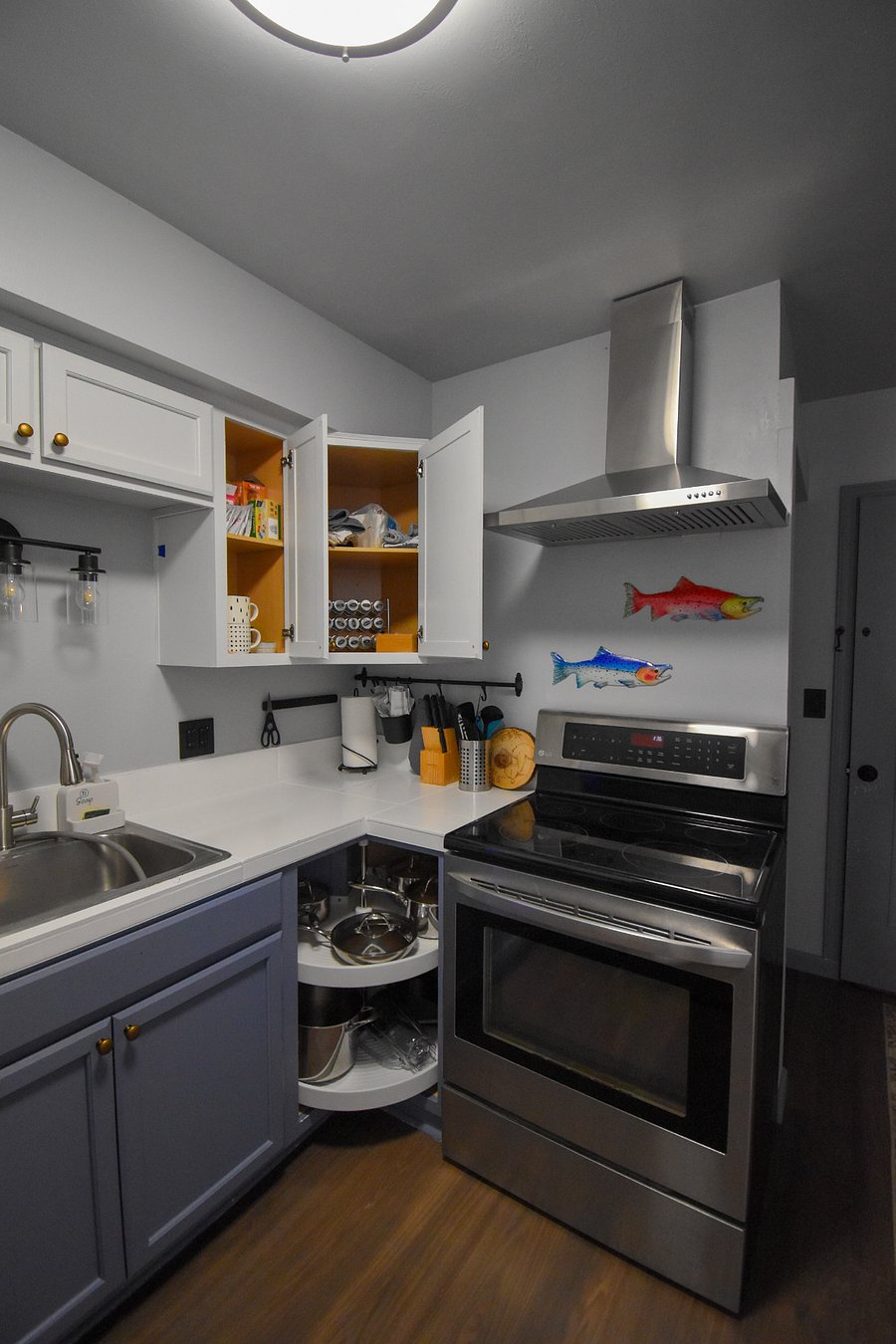 A cooks corner with a fully stocked spice rack, oil, and butter ready to go. Stainless steel pots and pans, dish cloths, and a vented range make it easy to whip up your favorite meals.