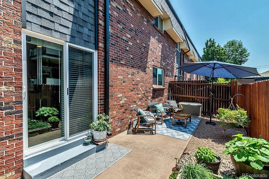 Old photo but more the vibe of the patio in the summer. Happy to get a new umbrella for back there if you are renting the place out in the summer. 
