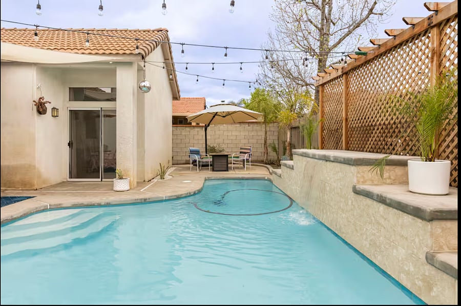 The firepit area has been upgraded with a cozy loveseat, two large cushioned chairs, and additional bench seating for relaxing and entertaining.