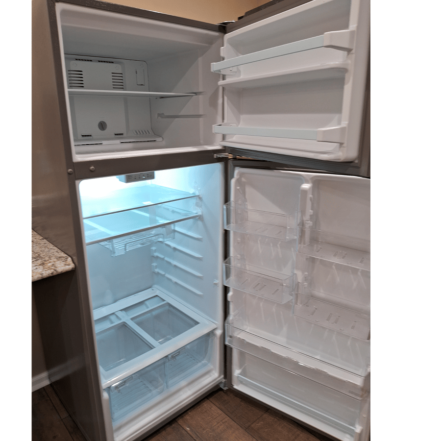 Full-size refrigerator with freezer above.