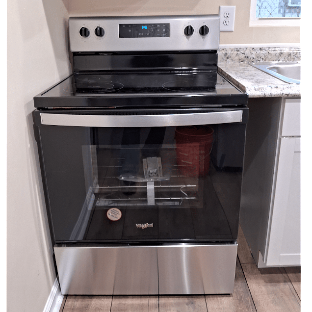 Smooth glass range top stove with oven below.