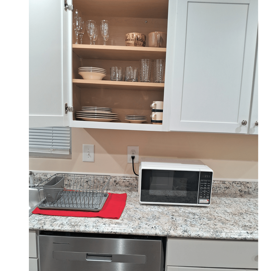 Dishware provided in cabinet above.