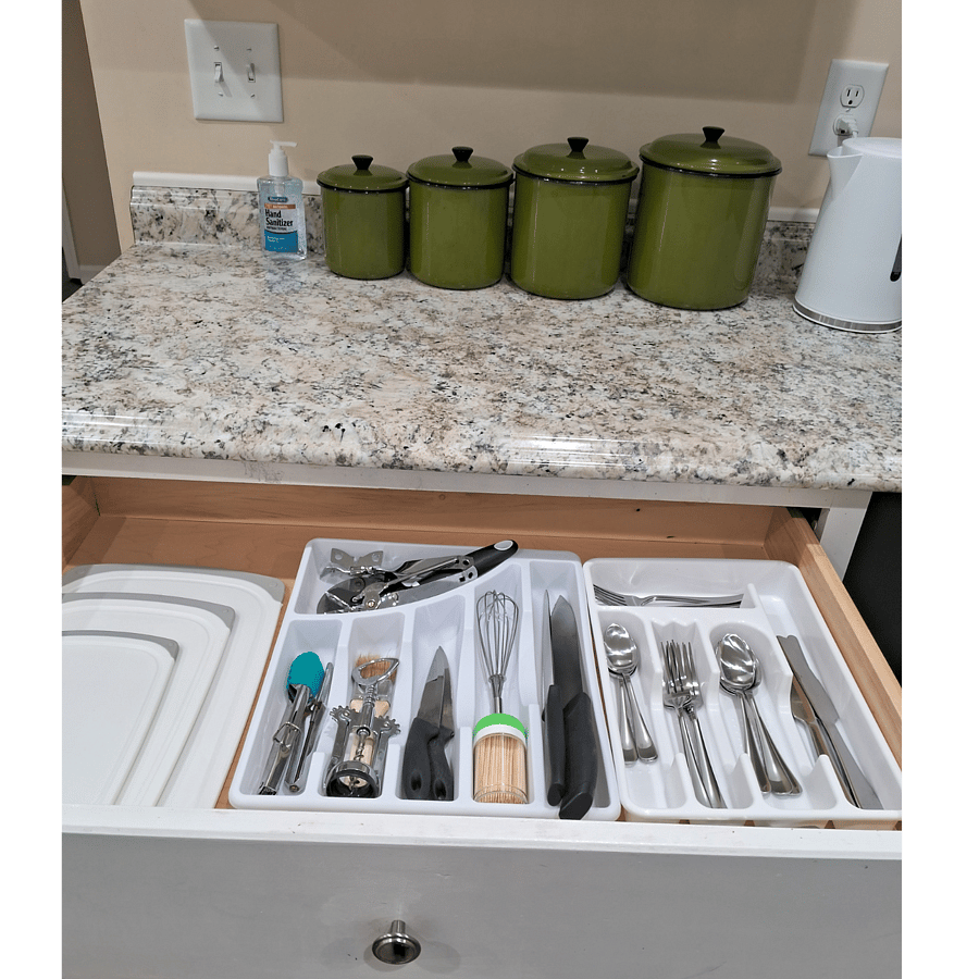 Kitchen utensils in top drawer.