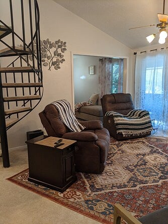 Living room view next to spiral staircase to upstairs ensuite bedroom.