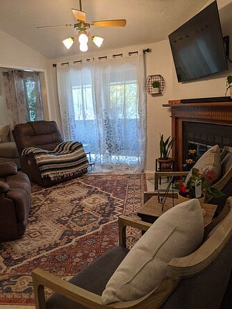 Living room with fireplace and sliding doors out to balcony.