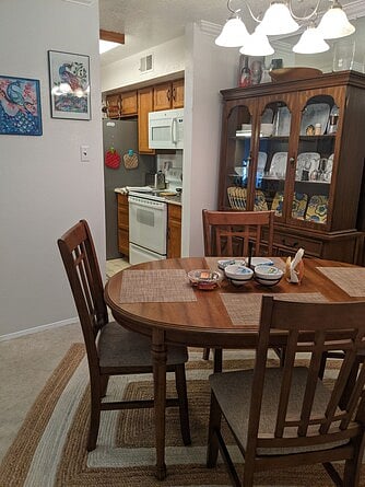 Dining room with a table for 4/6 and china cabinet.