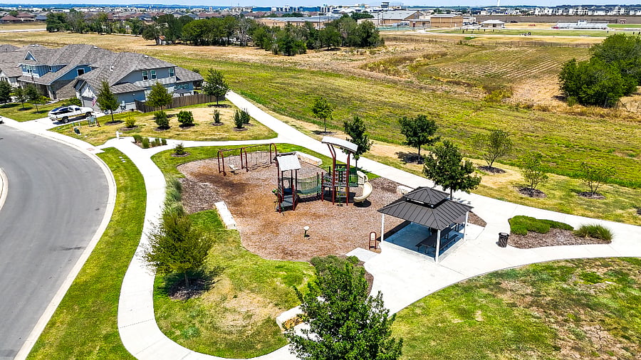 Neighborhood playground with shaded pavilion and picnic seating, ideal for families staying longer-term.