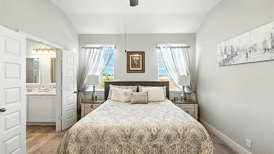 Primary bedroom with a king bed and calming, neutral dcoryour cozy retreat after a day exploring New Braunfels or working remotely.
