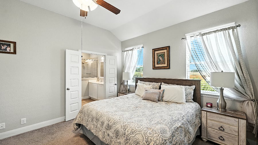 Alternate view of the primary bedroom highlighting the spacious layout and natural light.