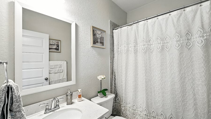Guest bathroom with clean finishes and a shower/tub combo, conveniently located near the secondary bedrooms.