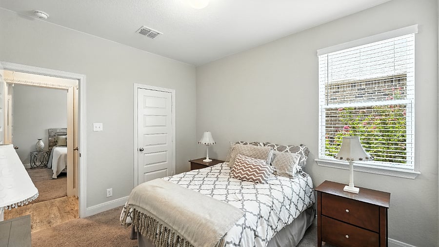 Cozy guest bedroom with comfy bedding, soft natural light, and a calm, relaxing vibeperfect for a great nights sleep during your stay.