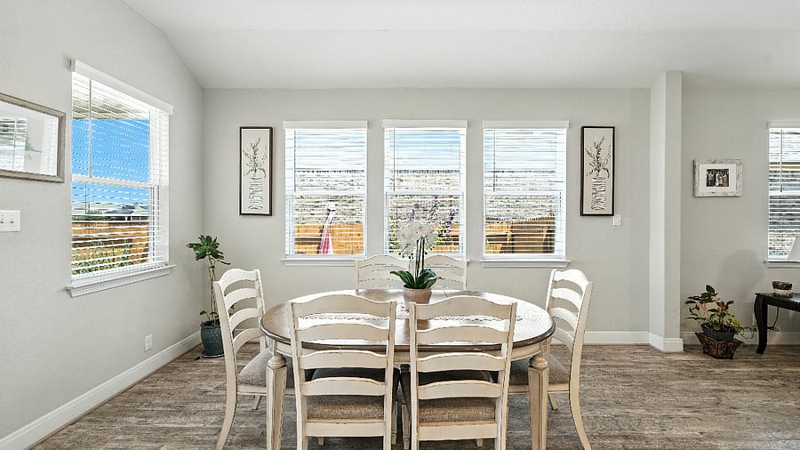 Dining area with seating for six, surrounded by windows that bring in tons of natural lightperfect for shared meals or game nights.