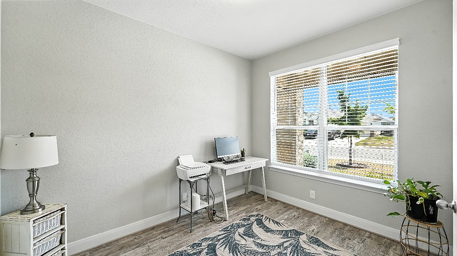 Alternate view of the office area with natural light and functional workspace.