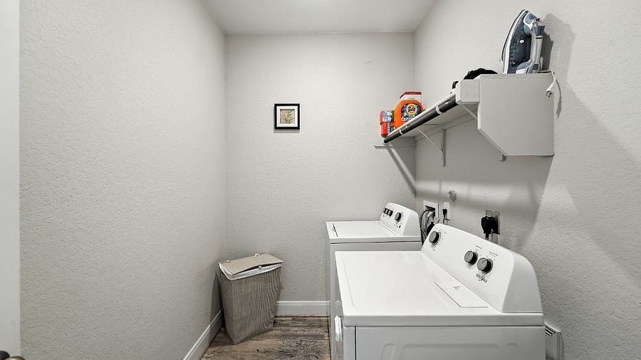 Laundry area conveniently located for longer staysbecause real life still happens on vacation.