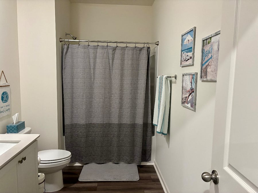 Guest bathroom with shower and tub combination with a large linen closet.