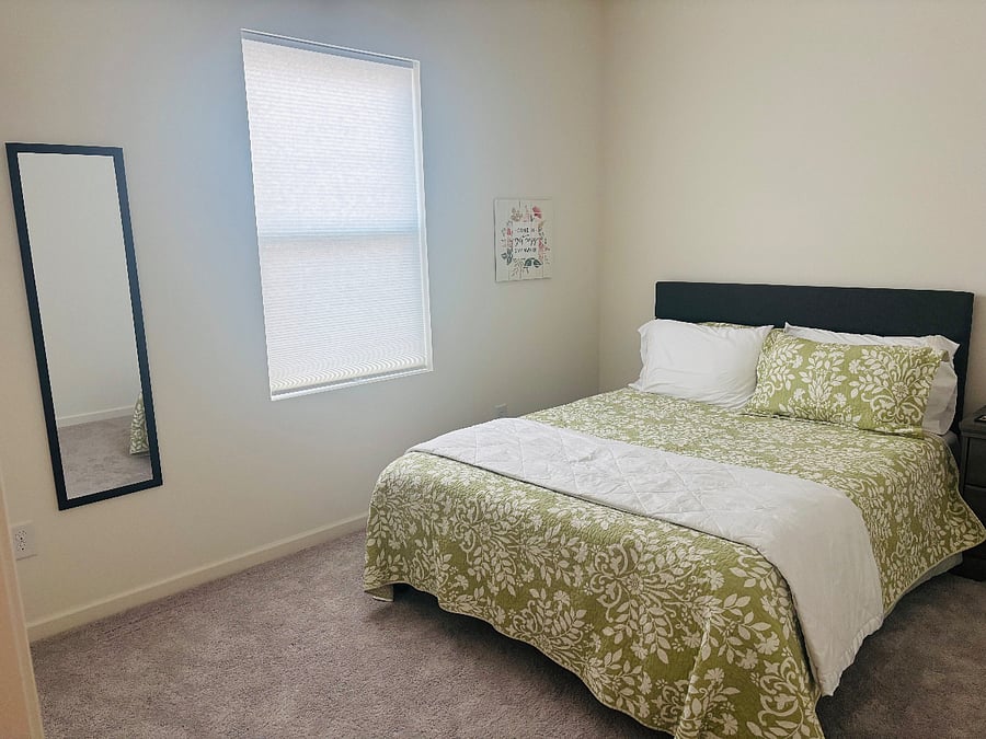 Guest bedroom with full length mirror. Bedroom is located across from the office/den.