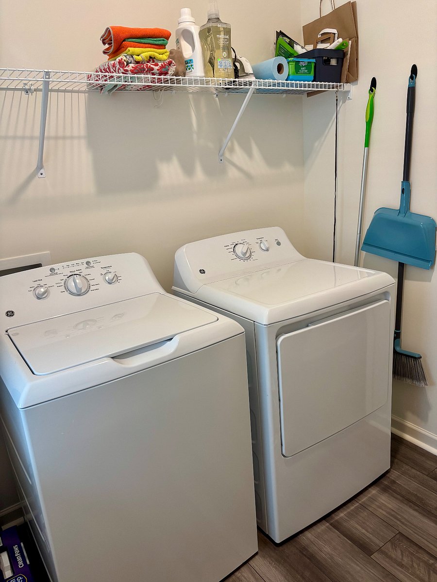 New washer & dryer in separate laundry-room off kitchen area.