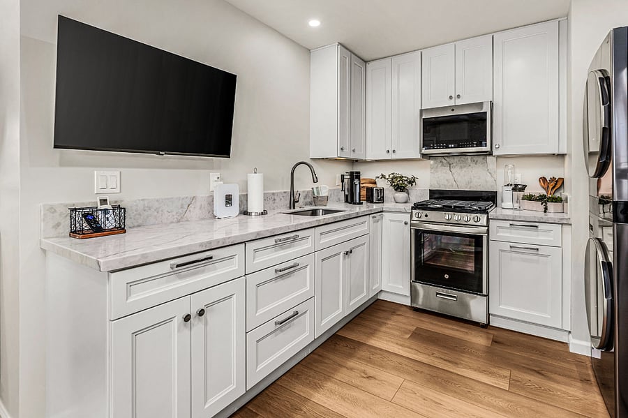 Spacious quartz counters, cabinets and drawers and a 40 Roku Smart TV on a swivel/tilt mount for viewing in both the kitchen and living area.