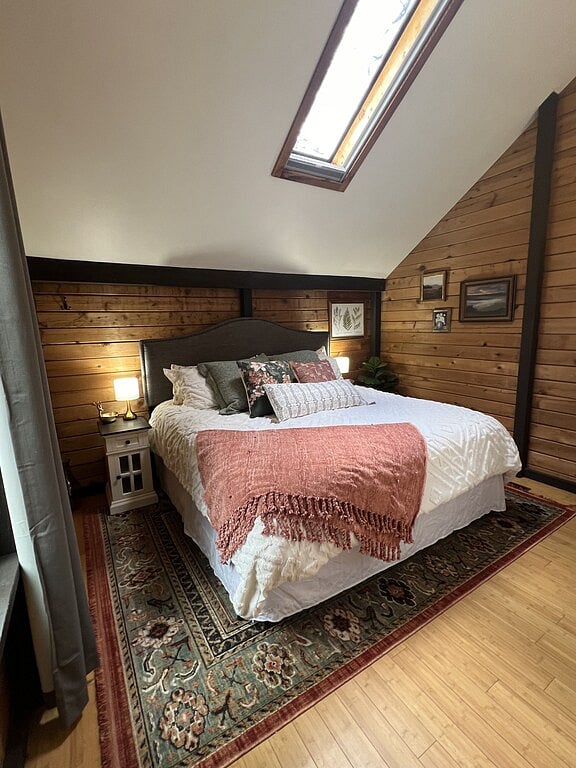 Master bedroom on main floor with king sized bed and Smart tv