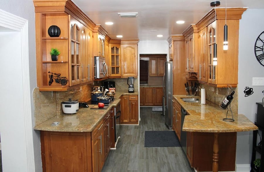 Chef Kitchen, with toaster, rice cooker, air fryer, waffle maker, dishwasher, fully stocked chef size fridge with ice maker, microwave, stove top and in wall oven. 
