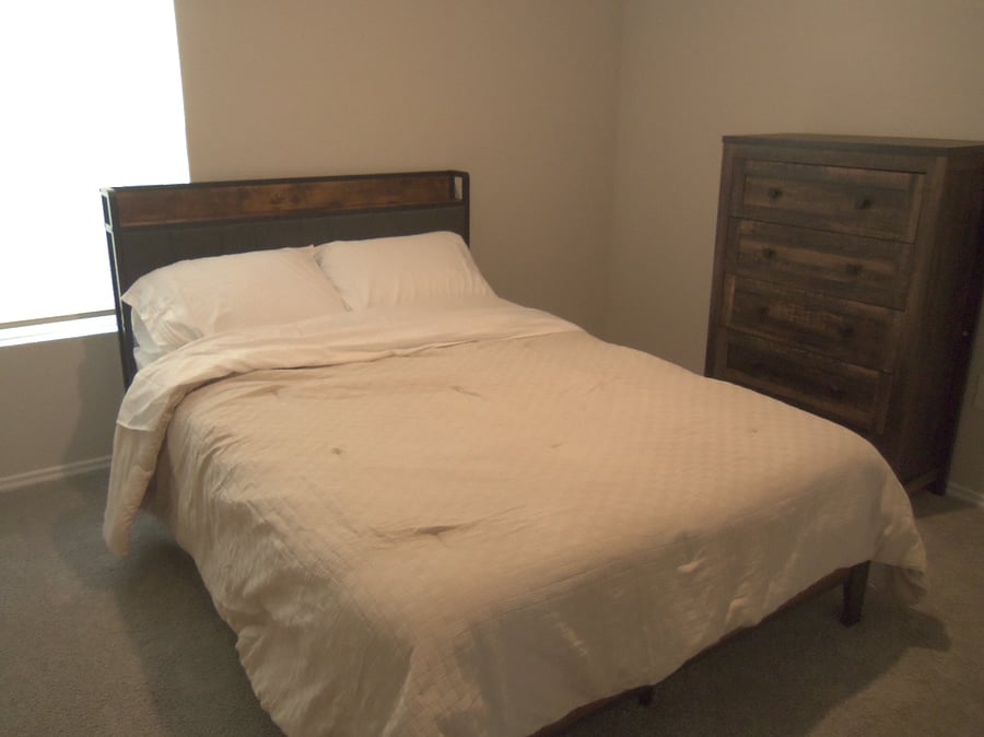 Secondary bedroom, full size bed, dresser and closet.