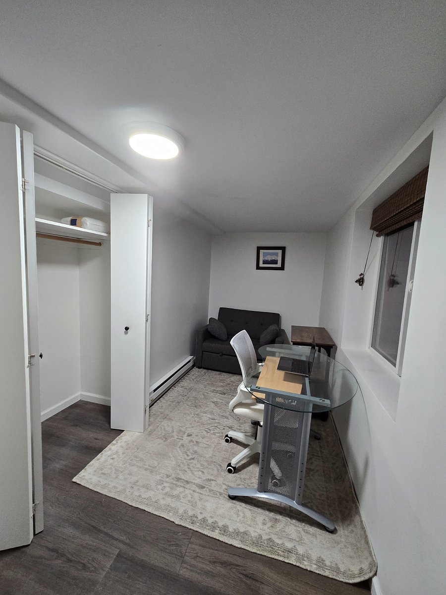 Second bedroom/office with pull out couch for extra sleeping, desk, desk chair, shelving and large closet.
