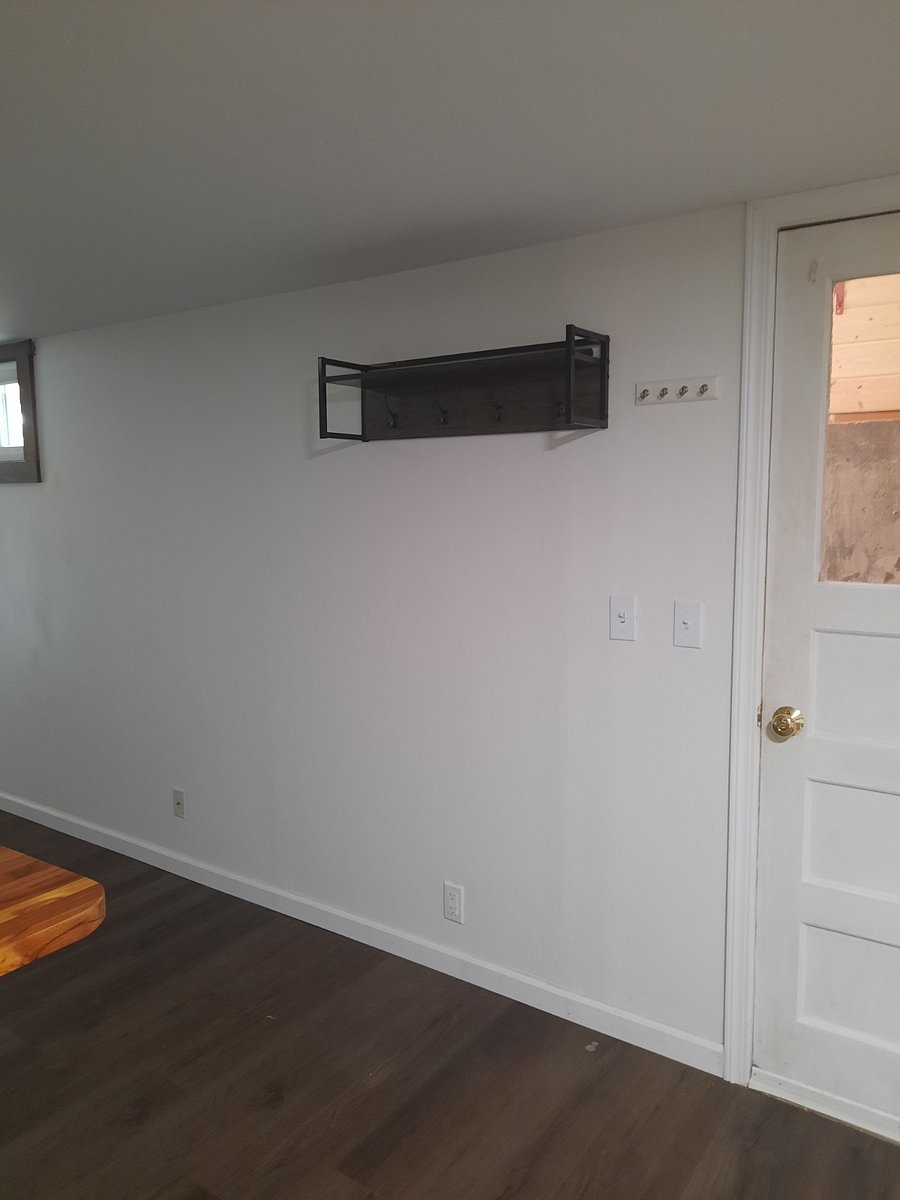 entrance coat rack and there is also an ottoman with for extra seating and shoe storage as well as a key hanger.