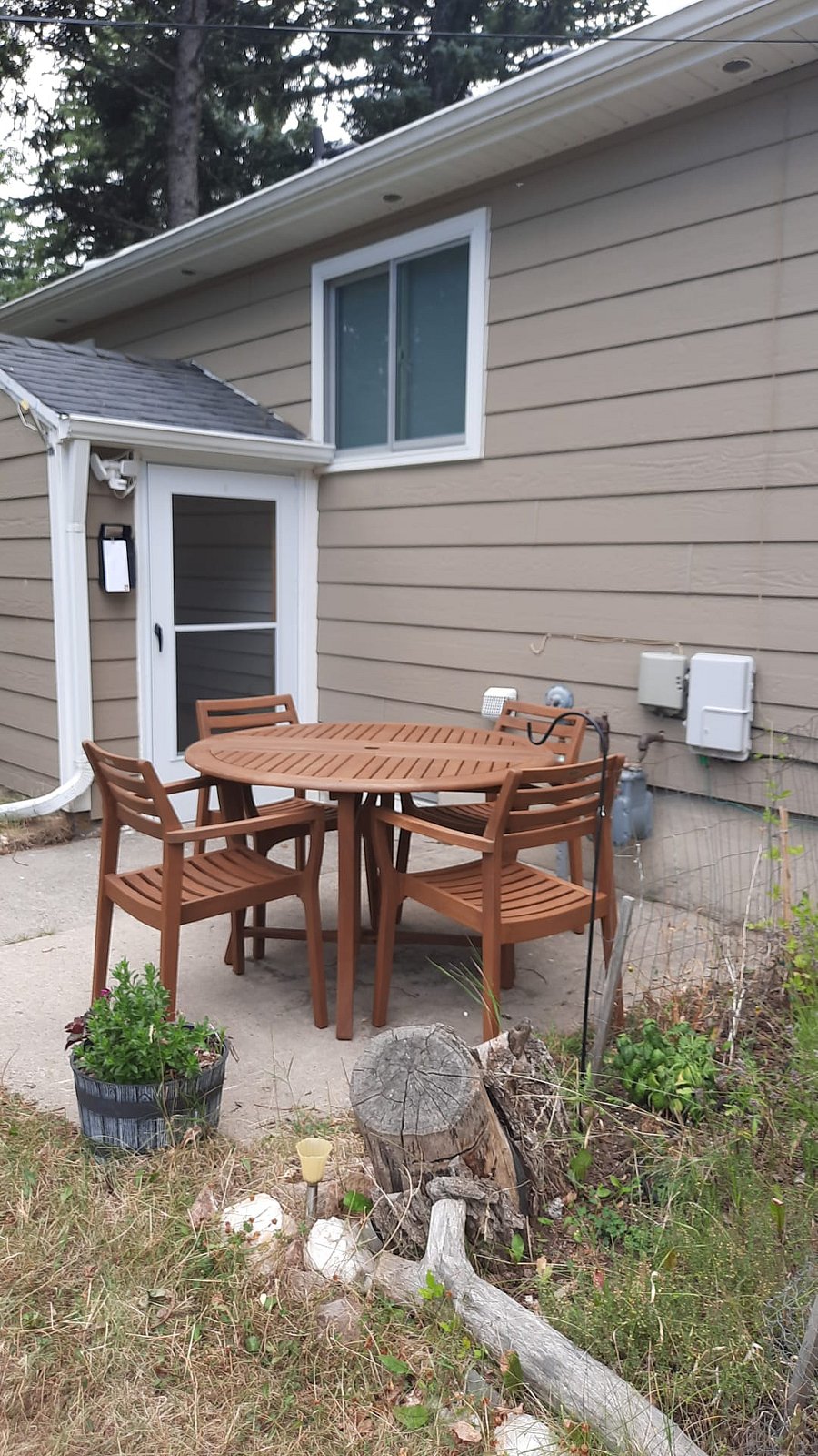 Private entrance with designated patio and patio furniture for tenants.