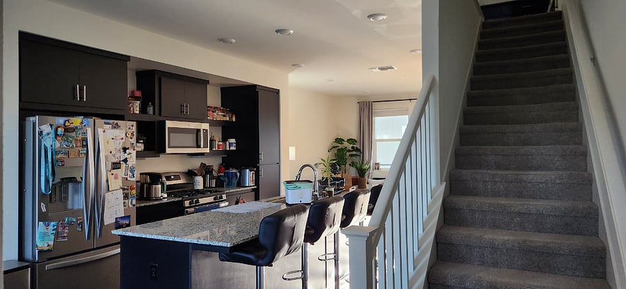 2nd floor view of kitchen, living room, and stairs to 3rd floor.