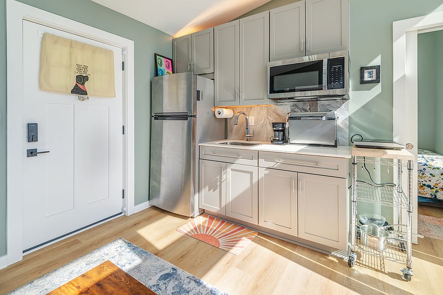 Kitchenette with microwave, induction cooktop, Ninja air fryer and toaster oven.
