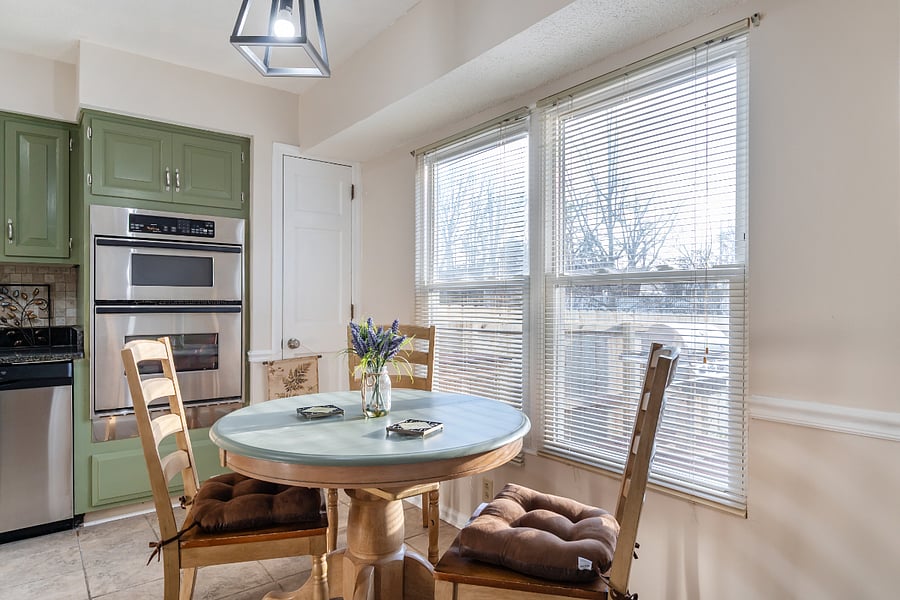 Kitchen has a window with a view of the backyard