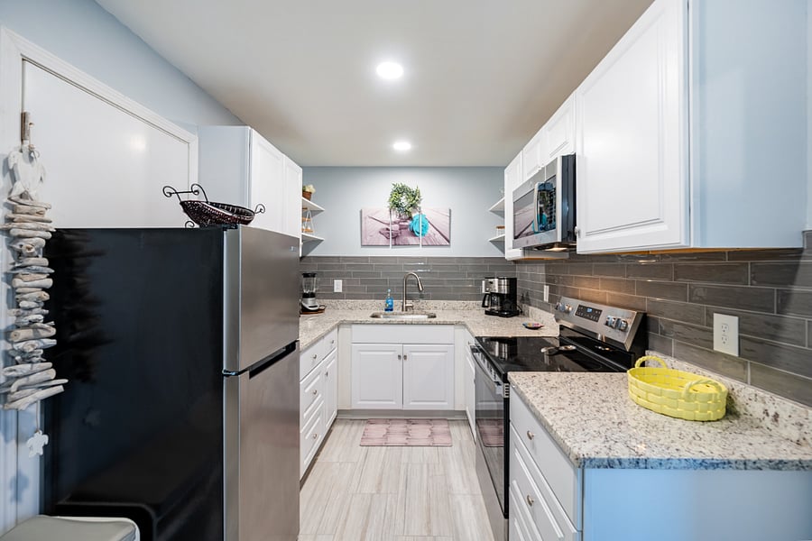 Kitchen, with granite surfaces, is stocked with all the pots, pans, and utensils you may need for your stay!