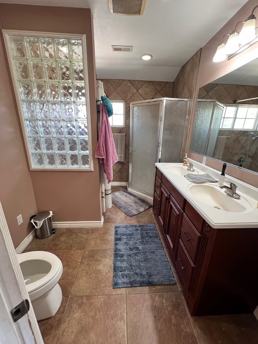 Upstairs shared bathroom with shower and tub