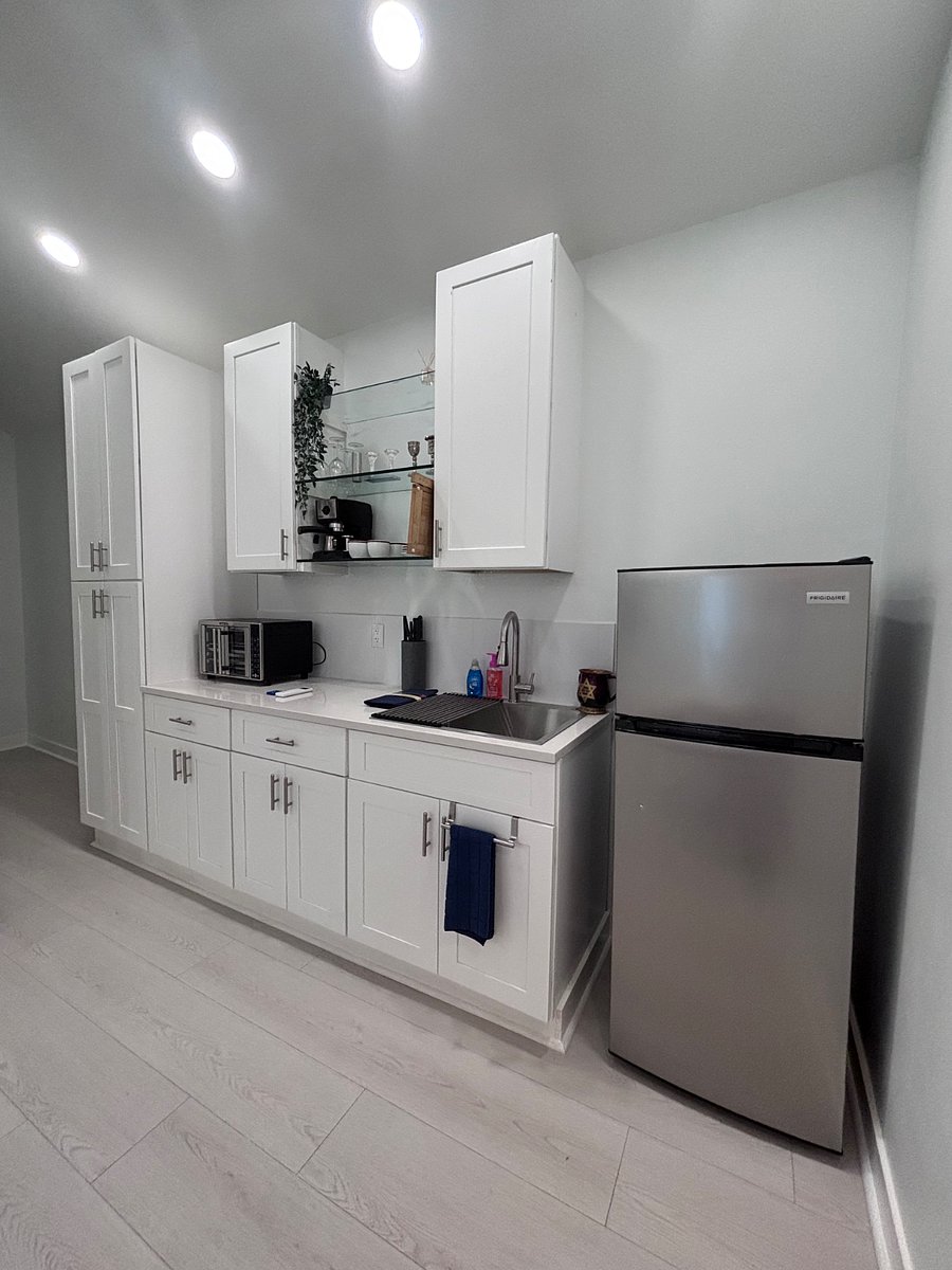 Fully equipped kitchen with additional small appliances neatly stored away from sight.