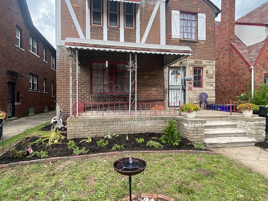 The front porch is a cozy area with shaded seating.