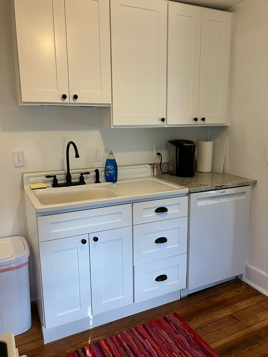 Fully equipped kitchen with dishwasher, fridge, stove/oven, microwave, & pantry space.